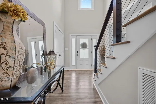 a view of a livingroom with furniture stairs wooden floor and staircase