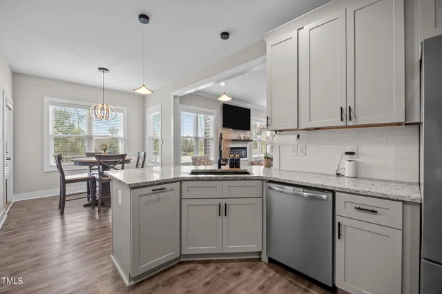 a kitchen with granite countertop cabinets stainless steel appliances and a window