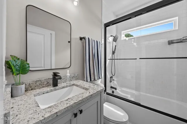 a living room with a couch and a book shelf