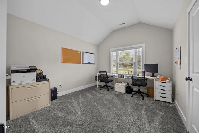 a view of empty room with cabinet and window