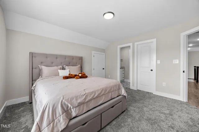 a bathroom with a granite countertop sink a toilet and a mirror