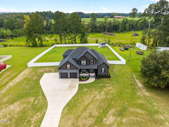 a view of a house with pool and a yard