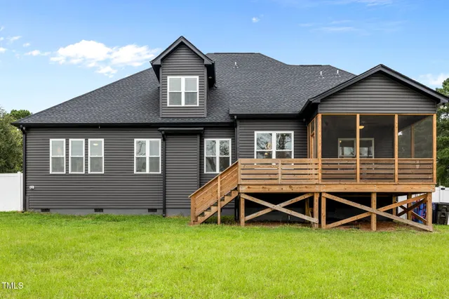 a view of a house with a yard and deck
