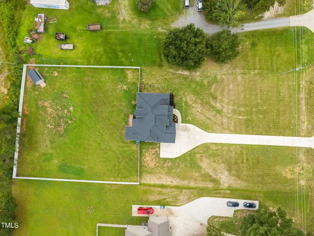 an aerial view of a house with swimming pool garden and patio