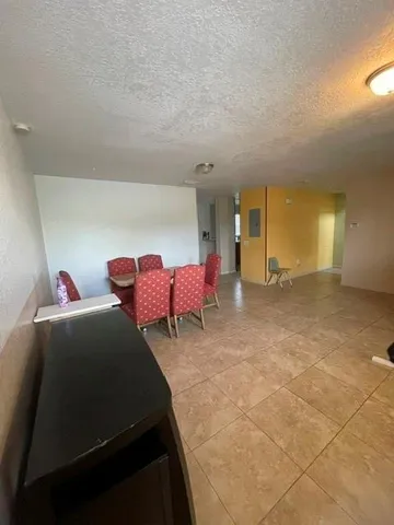 a spacious bedroom with a bed and a table in it