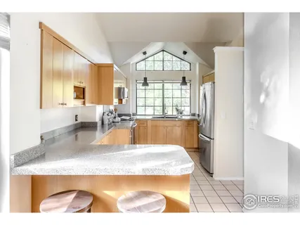 a large kitchen with granite countertop a window and a sink