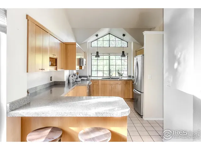 a large kitchen with granite countertop a window and a sink