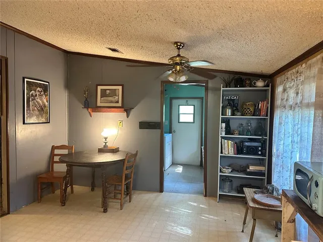 a view of a livingroom with workspace and a window