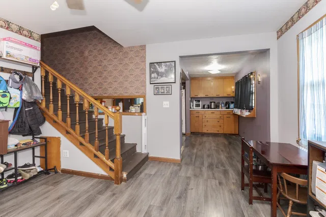 a bedroom with a bed and dresser with mirror