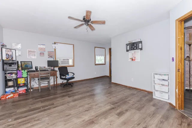 a view of a house with a yard and a large tree