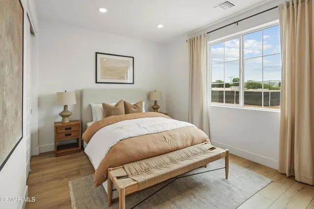 a bed room with a bed and a chair