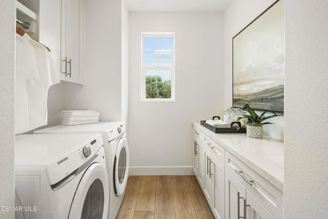 a utility room with a sink a washer and dryer