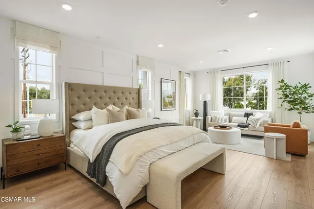 a spacious bedroom with a large bed and windows