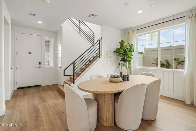 a dining room with furniture and wooden floor