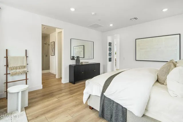 a spacious bedroom with a bed and a view of bathroom
