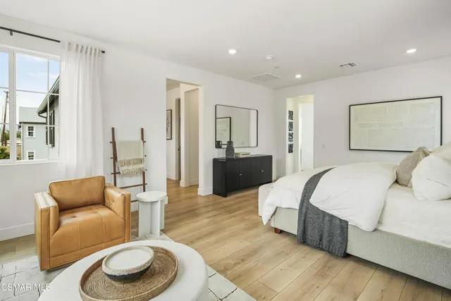 a spacious bedroom with a bed and a couch