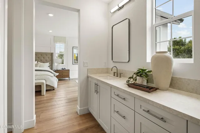 a spacious bathroom with a double vanity sink and a mirror