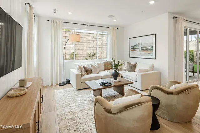 a living room with furniture and a large window