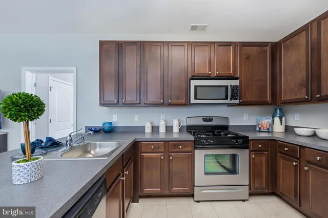 a kitchen with a sink stove and microwave