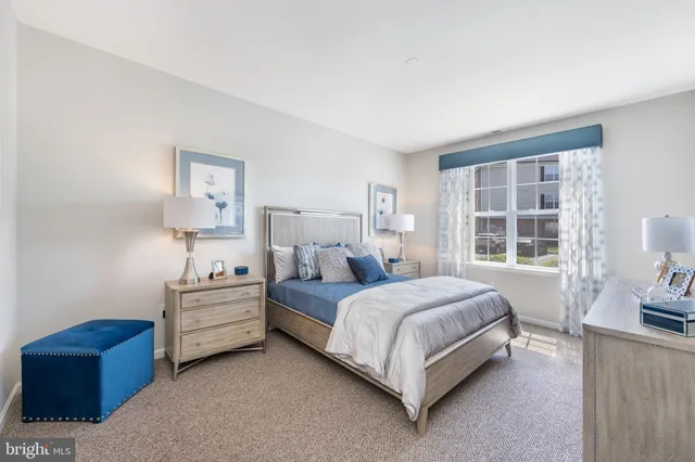 a bedroom with a bed couch and window