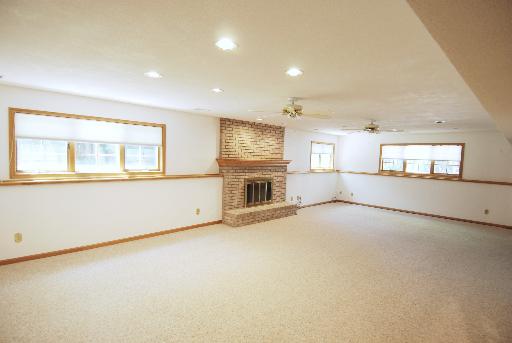 3002 Robinson Road Rockford, IL 61114 - Photo 11 of 13 an empty room with fireplace and windows