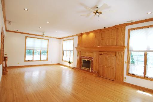 3002 Robinson Road Rockford, IL 61114 - Photo 5 of 13 a view of an empty room with a window and wooden floor