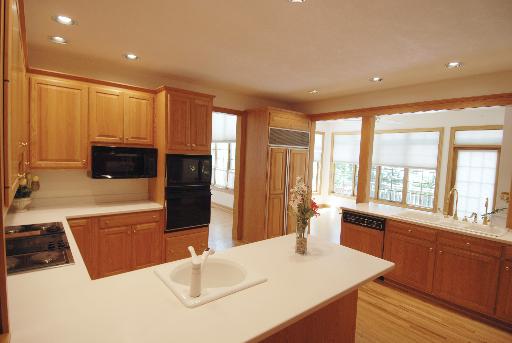 3002 Robinson Road Rockford, IL 61114 - Photo 7 of 13 a large kitchen with kitchen island a sink a counter space and stainless steel appliances