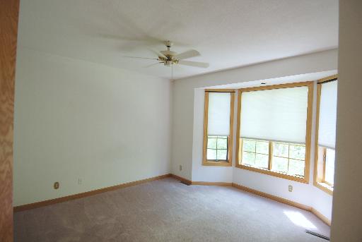 3002 Robinson Road Rockford, IL 61114 - Photo 8 of 13 an empty room with a window and a fan