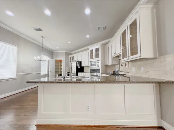 a kitchen with stainless steel appliances granite countertop a sink and cabinets