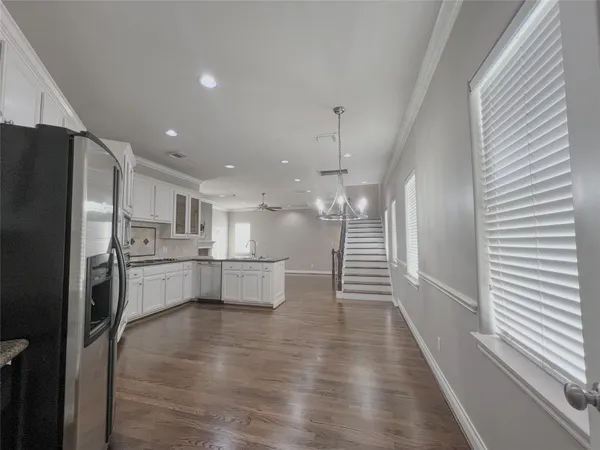 a kitchen with white cabinets and stainless steel appliances