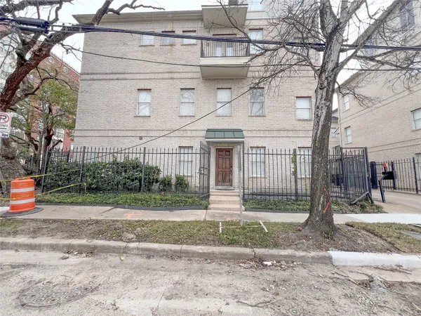 a front view of a house with a yard and plants
