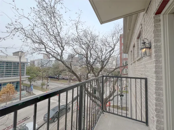 a view of a balcony with wooden fence and floor