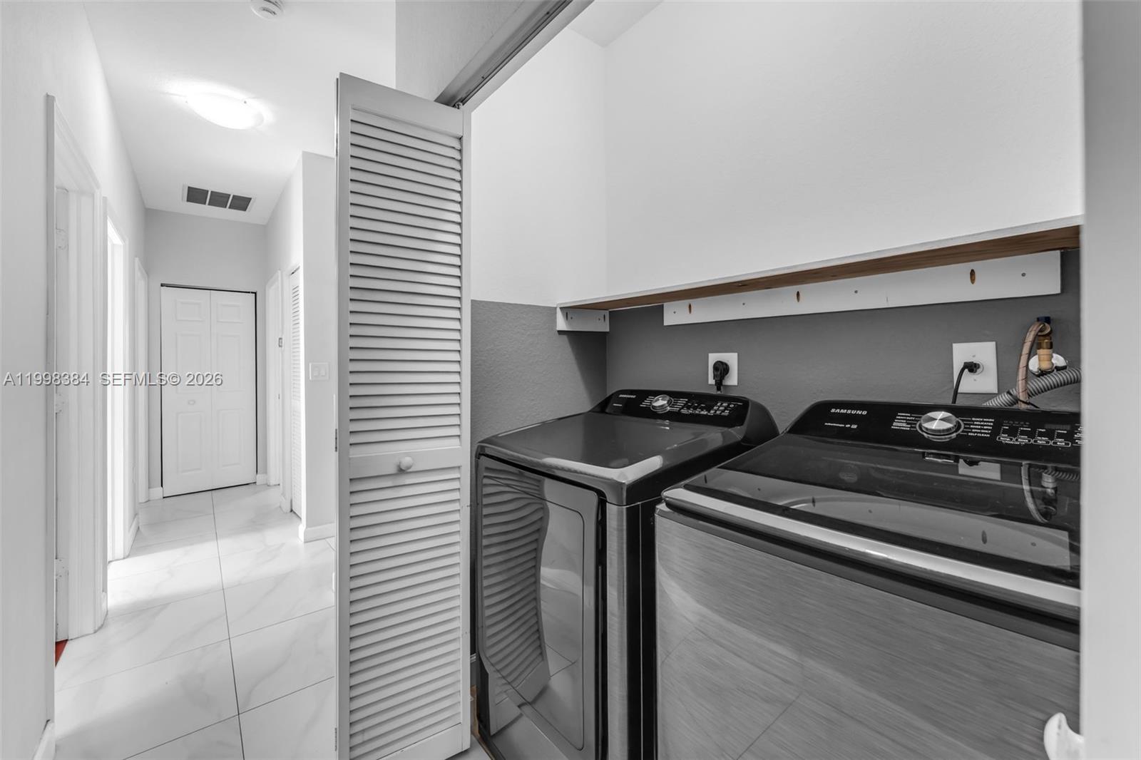 239 Southeast 31st Terrace Homestead, FL 33033 - Photo 26 of 49 a kitchen with stainless steel appliances granite countertop a sink and cabinets