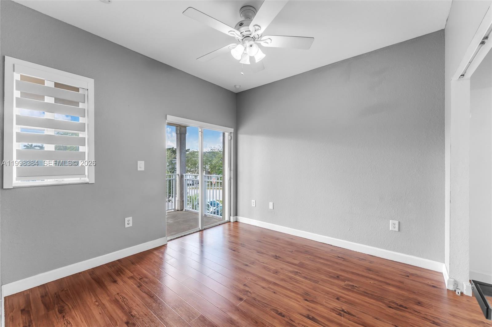 239 Southeast 31st Terrace Homestead, FL 33033 - Photo 30 of 49 a view of an empty room with window and wooden floor