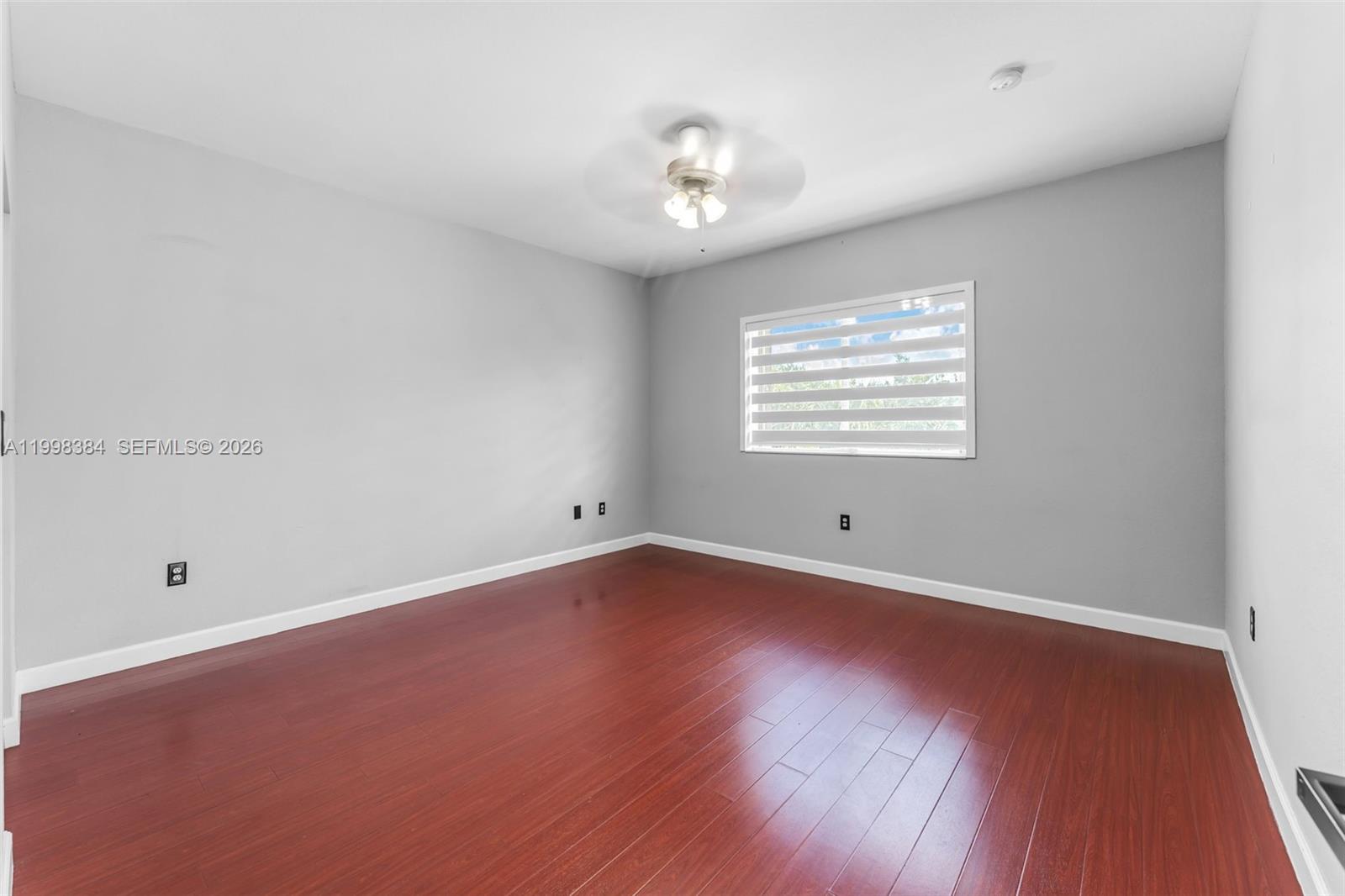 239 Southeast 31st Terrace Homestead, FL 33033 - Photo 37 of 49 a view of an empty room with a window and wooden floor