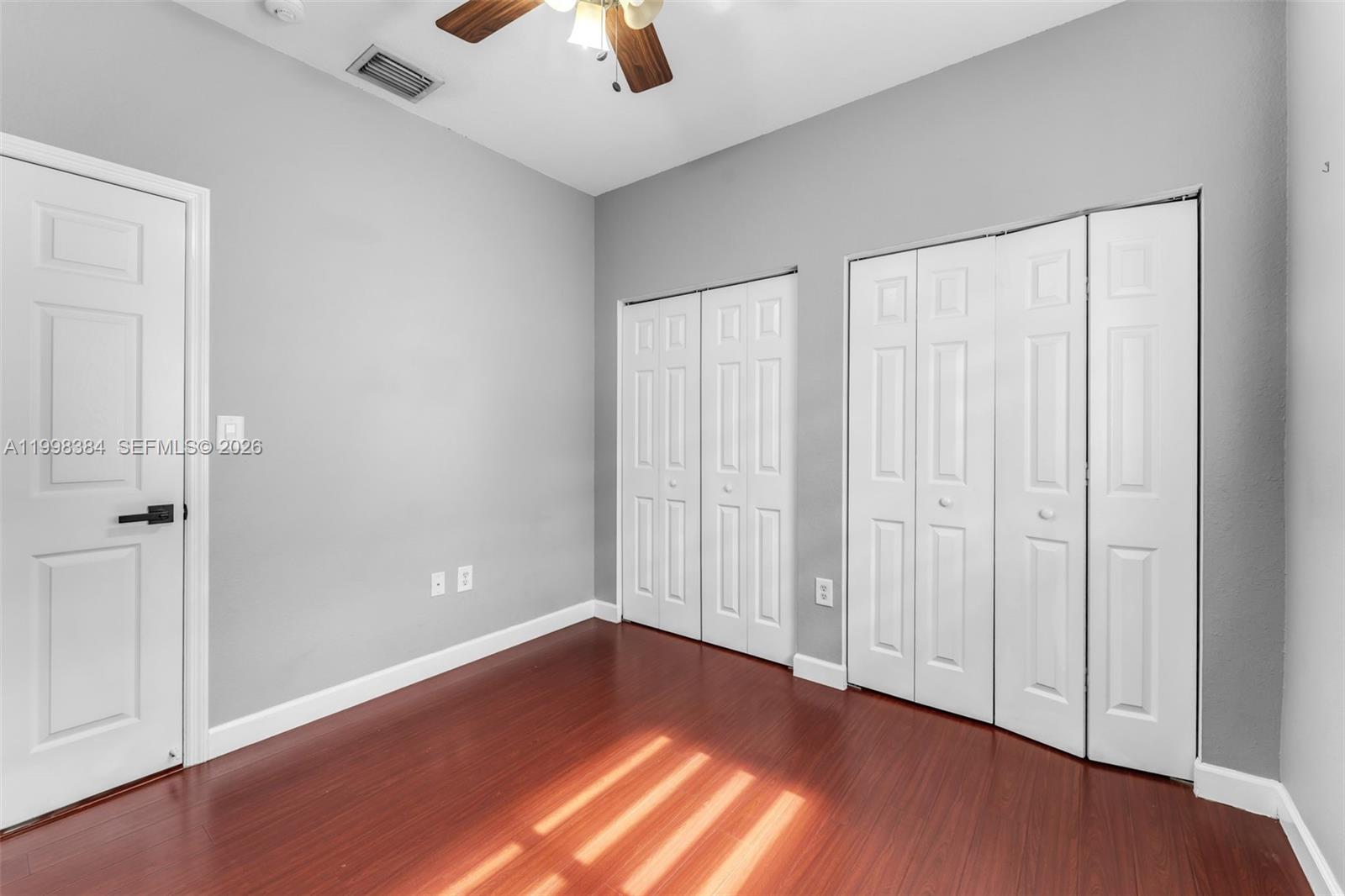 239 Southeast 31st Terrace Homestead, FL 33033 - Photo 38 of 49 an empty room with wooden floor closet and windows