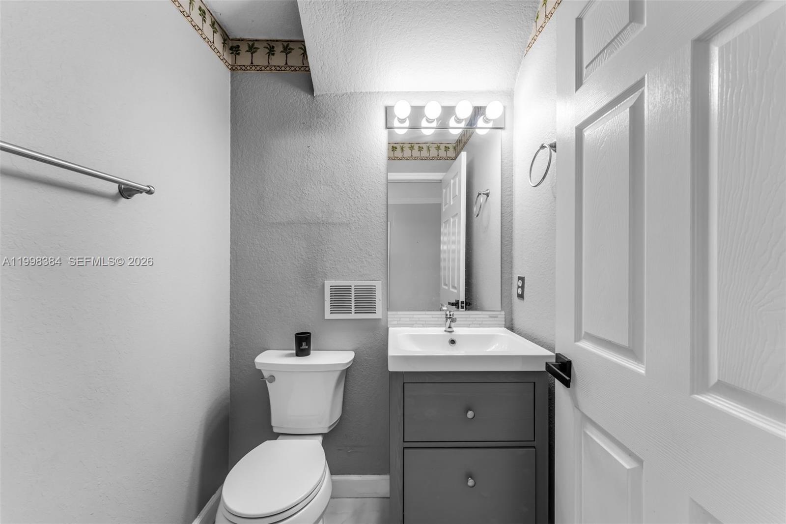 239 Southeast 31st Terrace Homestead, FL 33033 - Photo 41 of 49 a bathroom with a toilet sink and mirror