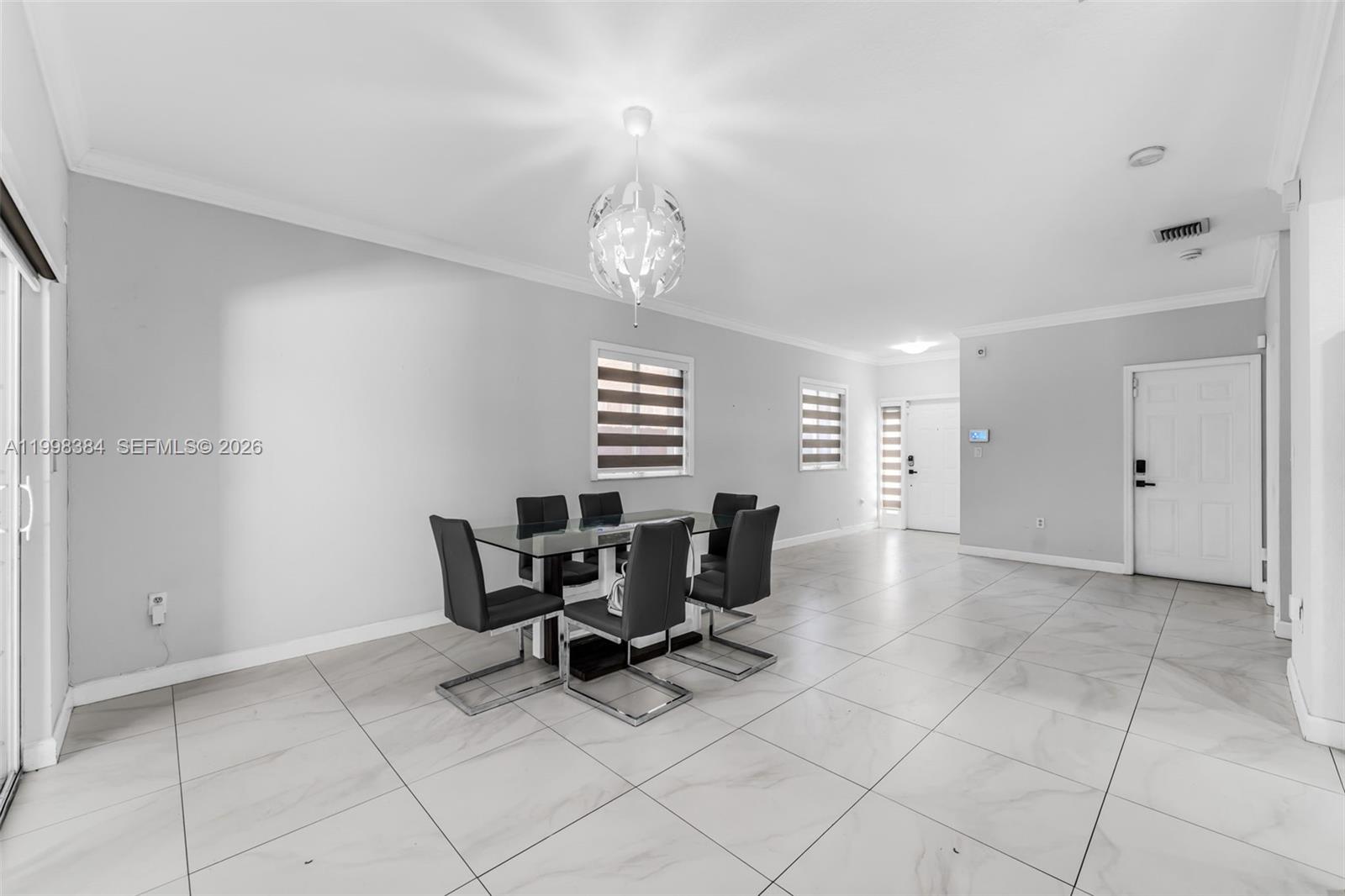 239 Southeast 31st Terrace Homestead, FL 33033 - Photo 44 of 49 a view of a dining room with furniture and chandelier