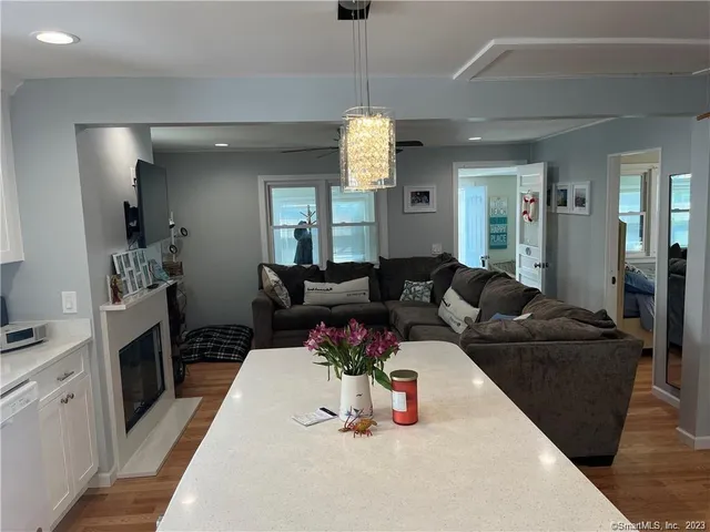 a living room with furniture and a chandelier