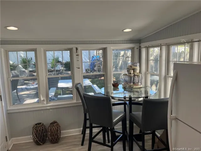 a dining room with furniture and window