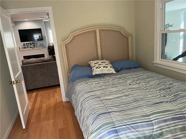 a bedroom with a bed and a television