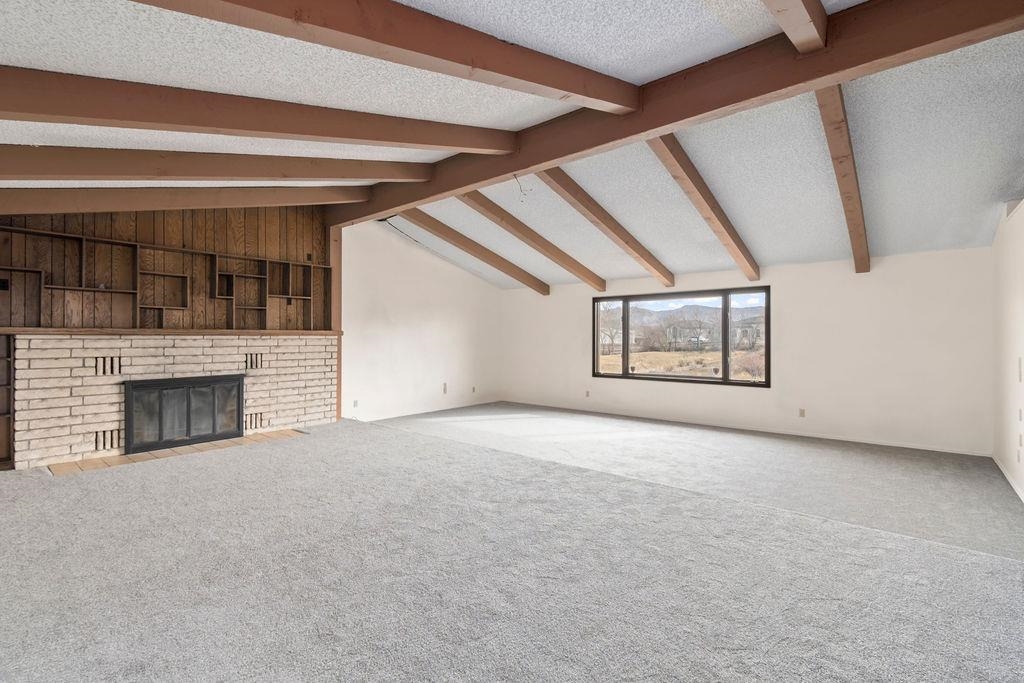 2590 I Road Grand Junction, CO 81505 - Photo 12 of 41 an empty room with fireplace and windows