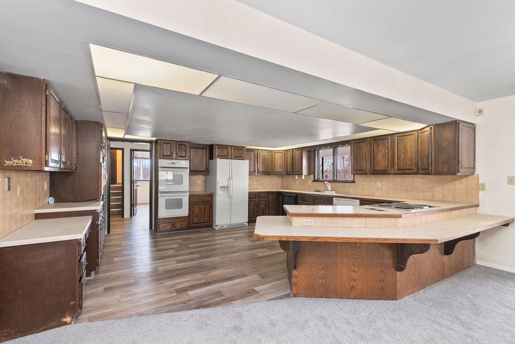 2590 I Road Grand Junction, CO 81505 - Photo 8 of 41 a view of a kitchen with cabinets and wooden floor