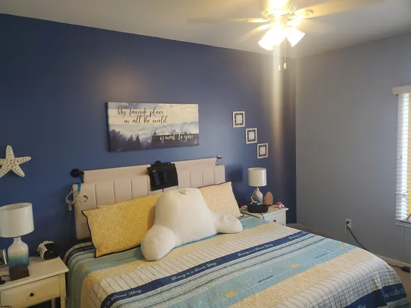 a bedroom with bed and a chandelier