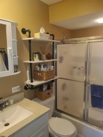 a bathroom with a sink toilet and shower