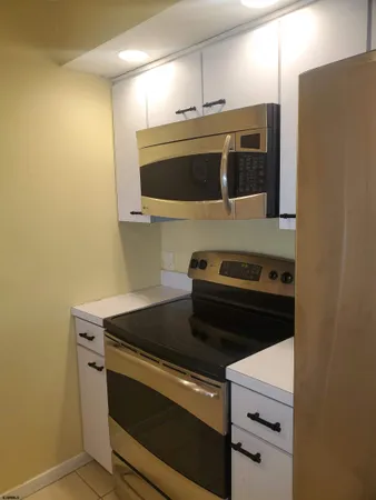 a stove top oven sitting inside of a kitchen