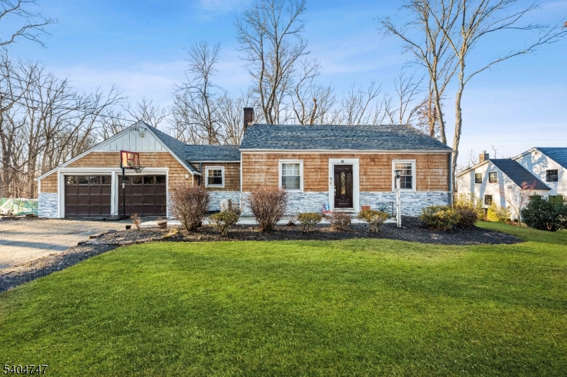 45 Dreahook Road Somerville, NJ 08876 - Photo 2 of 26 a backyard of a house with table and chairs and a large tree