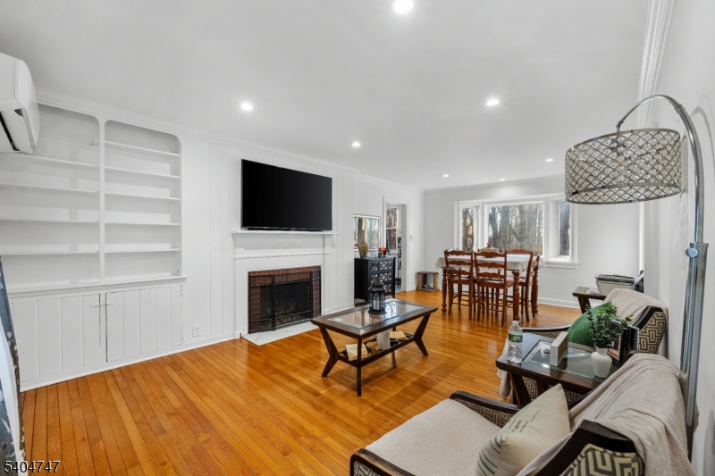 45 Dreahook Road Somerville, NJ 08876 - Photo 3 of 26 a living room with furniture a fireplace and a flat screen tv