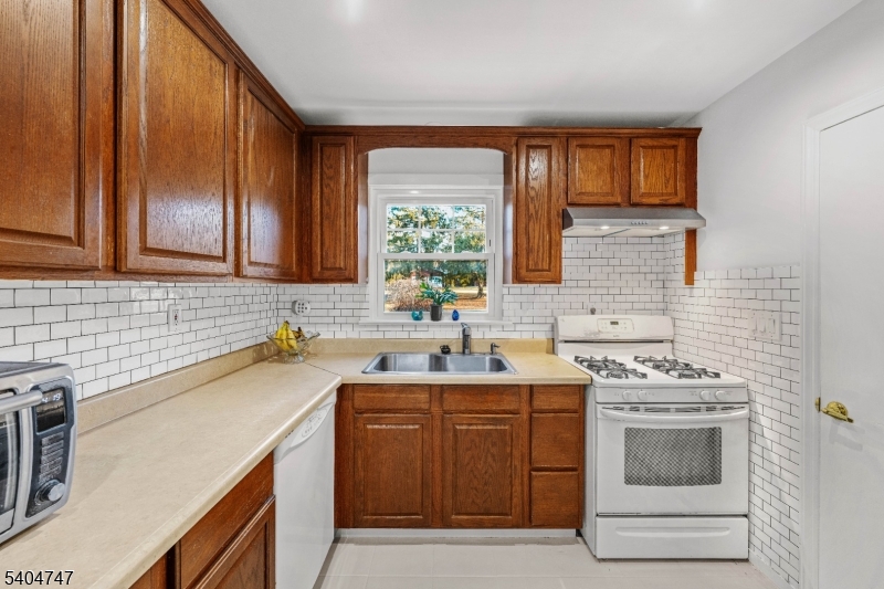 45 Dreahook Road Somerville, NJ 08876 - Photo 7 of 26 a kitchen with a sink stove and cabinets