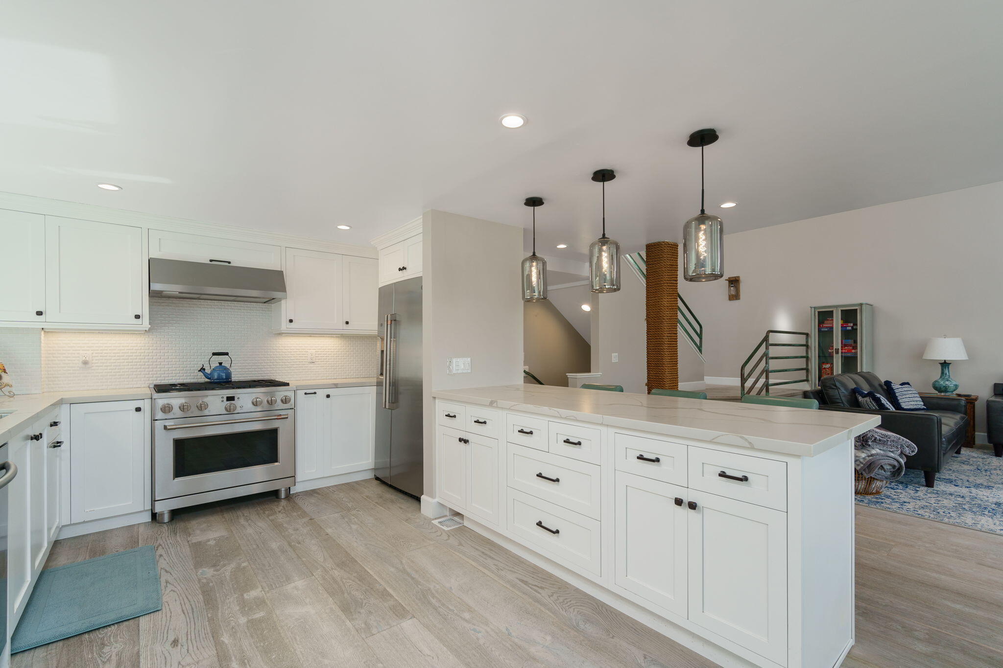 5235 Sealane Way Oxnard, CA 93035 - Photo 11 of 53 a kitchen with white cabinets and stainless steel appliances
